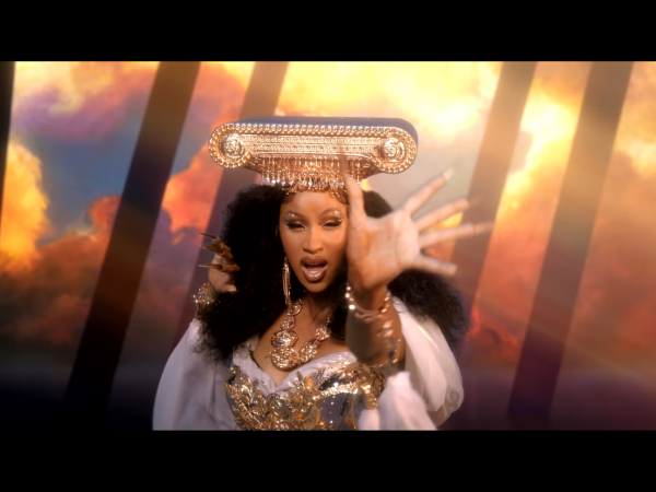 screenshot of cardi b from rumors video with gold headpiece and bedazzled eyebrows